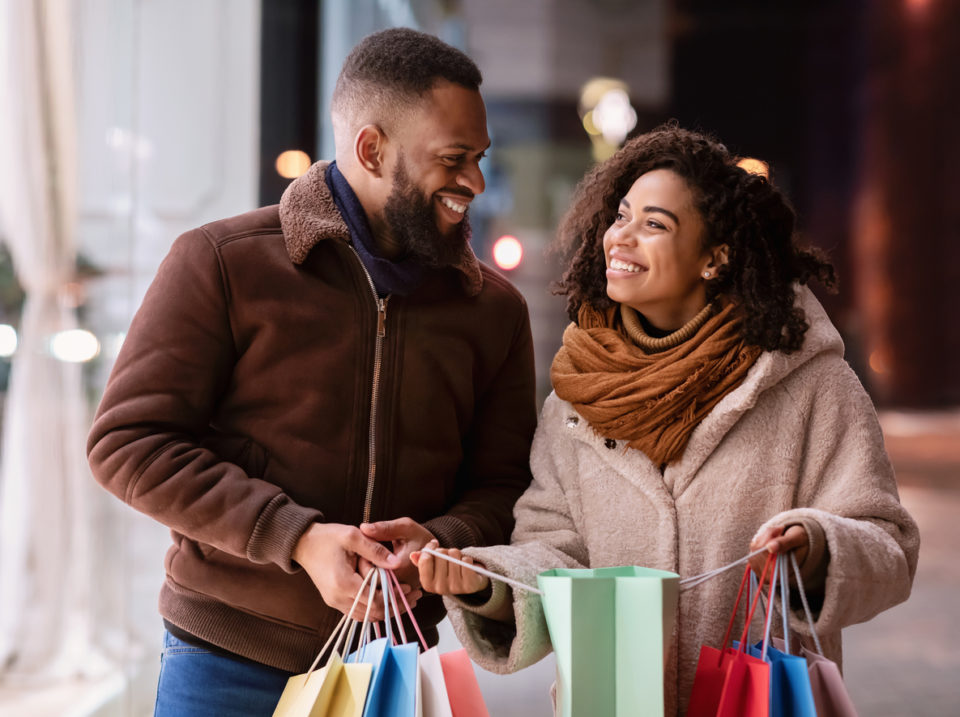 happy couple holiday shopping