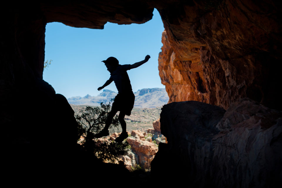 Boy Exploring a Cavern